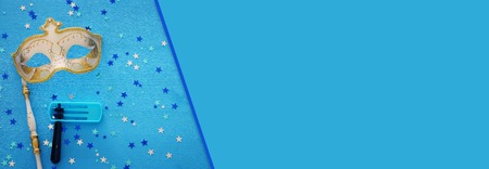 Purim celebration concept (Jewish carnival holiday) over blue wooden background. Top viewの写真素材