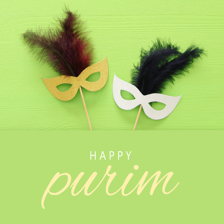 Purim celebration concept (Jewish carnival holiday) over green wooden background. Top view.の写真素材
