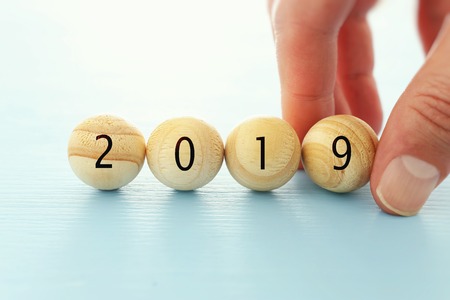 Wooden balls and cubes with the digits 2019 - New Year, success and planning conceptの写真素材