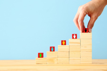 Photo of blocks with people icons over wooden table, human resources and management concept