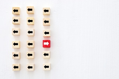 Concept of think different, innovation and creativity. Red cube changing direction from othersの写真素材