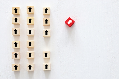 Concept of think different, innovation and creativity. Red cube changing direction from othersの写真素材
