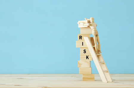 wooden dummy climbs a dangerously unstable structure and risks fallingの写真素材