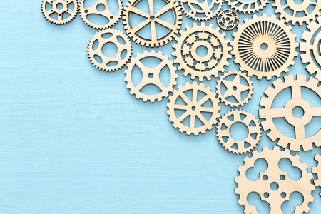 working system of cogwheels, teamwork, flat lay, pastel yellow backgroundの写真素材