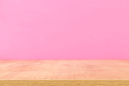 Empty table in front of pastel pink background. For product display montageの写真素材