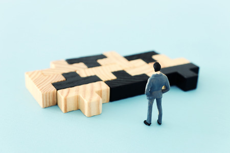 puzzle blocks with miniature people over wooden table ,human resources, problem solving and management conceptの写真素材