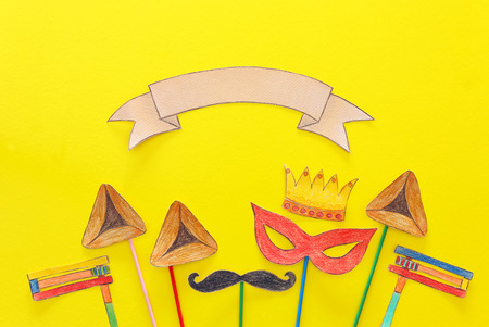 Purim celebration concept (jewish carnival holiday). Traditional hamantash cookies cutted from paper and paintedの写真素材