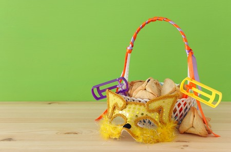 Purim celebration concept (Jewish carnival holiday). Traditional hamantaschen cookies in the basket over wooden tableの写真素材
