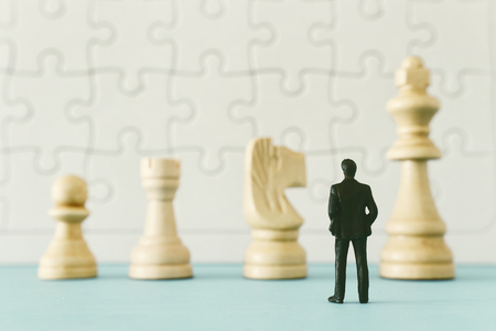 chesss with miniature people over wooden table ,human resources, problem solving and management conceptの写真素材