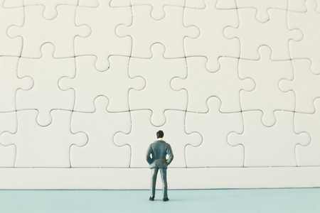 puzzle blocks with miniature people over wooden table ,human resources, problem solving and management conceptの写真素材