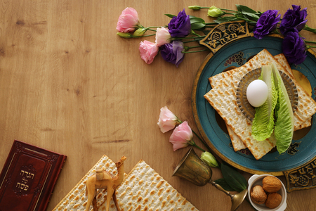 Pesah celebration concept (jewish Passover holiday). Traditional book with text in hebrew: Passover Haggadah (Passover Tale) and plate with word MATZAHの写真素材