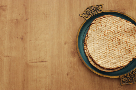 Pesah celebration concept (jewish Passover holiday). Translation for Hebrew Text over plate (Matzah)...