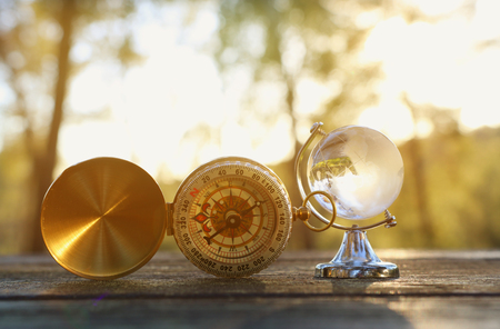 small crystal globe in front of sunset. travel and global issues conceptの写真素材