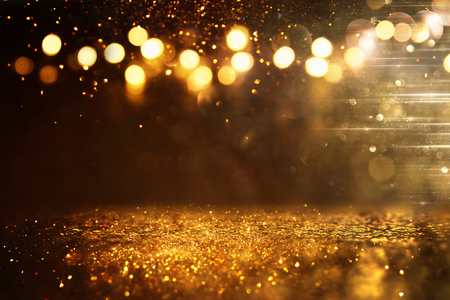 Glitter vintage lights background. Black and gold. De-focused.の写真素材