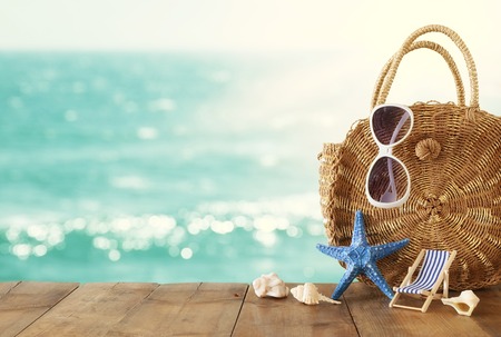 vacation and summer concept with sea life style objects over wooden table infront of sea landscape backgroundの写真素材