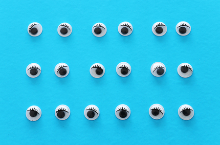 Many googly eyes over blue backgroundの写真素材