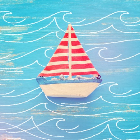 Wooden vintage boat over blue background.の写真素材