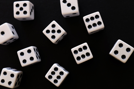 Rolling Dices over black background. Casino gambling conceptの写真素材