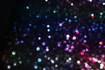 Glitter vintage lights background. Red, black, purple and blue. De-focusedの写真素材