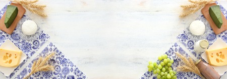 Top view photo of dairy products over white wooden background. Symbols of Jewish holiday - Shavuotの写真素材