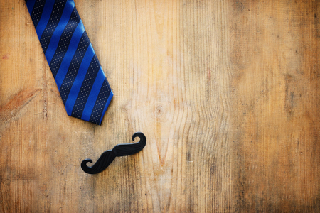 Father's day concept. Necktie and mustache over wooden background. Top view, flat layの写真素材