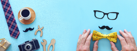 Father's day concept. Gift box, tie and funny moustache over wooden background. Top view, flat lay. bannerの写真素材