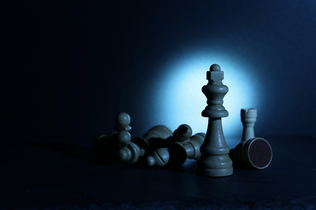 Wooden chess figuresunderdark and dramatic lightingの写真素材