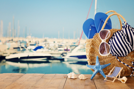 vacation and summer concept with sea life style objects over wooden table infront of sea landscape backgroundの写真素材