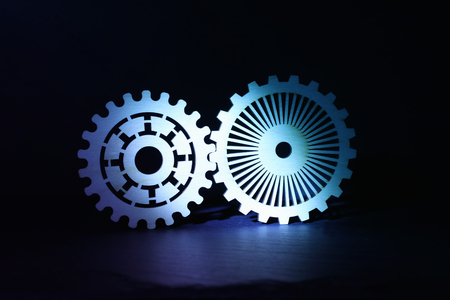 Industrial background. Gear in orange spotlight, new innovation and technology ideaの写真素材