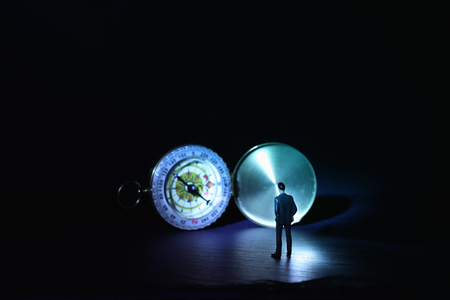 Leadership concept, miniature man looking at compass, inspiration and vision ideaの写真素材