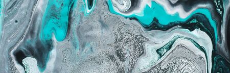 Photography of abstract marbleized effect background. Black, light turquoise and white creative...