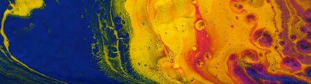 photography of abstract marbleized effect background. yellow, blue, purple and red creative colors. Beautiful paint. bannerの写真素材