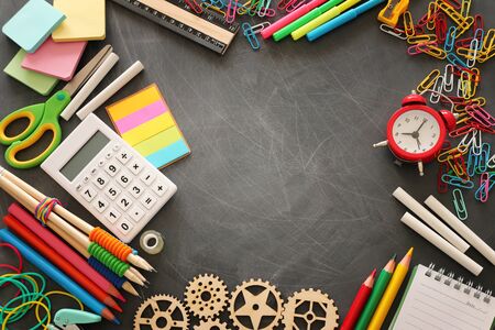 education and back to school concept. stationery over classroom blackboard. top view, flat layの写真素材