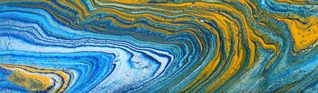 photography of abstract marbleized effect background. Blue, mint, yellow and white creative colors. Beautiful paint. bannerの写真素材