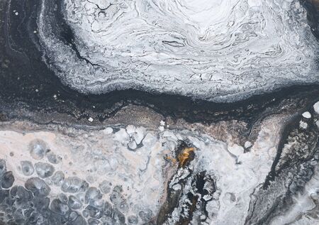 Photography of abstract marbleized effect background. Black, gold and white creative colors....