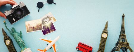 Top view photo of traveling concept with accessories and world symbols over blue backgroundの写真素材