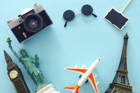 holidays image of traveling concept with accessories and world symbols over blue background. top view, flat layの写真素材