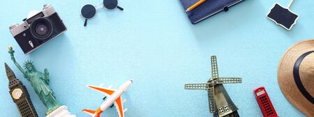 holidays image of traveling concept with accessories and world symbols over blue background. top view, flat layの写真素材