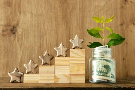 Business concept image of setting a five star goal. Increase rating or ranking, evaluation, money investment and financial growth conceptの写真素材