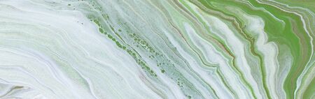 Photography of abstract marbleized effect background. Green and white creative colors. Beautiful...