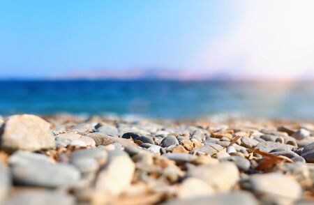 Holidays image of beach in front of summer sea with pebble stones background. Selective focusの写真素材