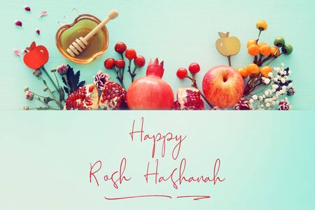 Religion image of Rosh hashanah (Jewish New Year holiday) concept. Traditional symbols over wooden mint blue pastel backgroundの写真素材