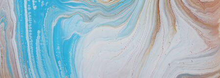 photography of abstract marbleized effect background. Blue, gold and white creative colors....