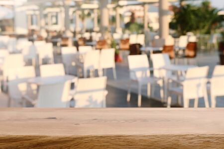 background Image of wooden table in front of blurred restaurant