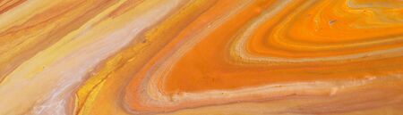 photography of abstract marbleized effect background. orange, gold, yellow and white creative...