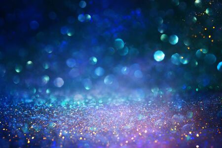 blackground of abstract glitter lights. blue, gold and black. de focusedの写真素材