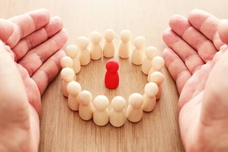 business concept image of tangram puzzle blocks with people figures over wooden table, human resources and management conceptの写真素材