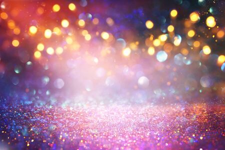 background of abstract red, gold and purple glitter lights. defocusedの写真素材