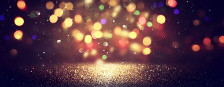 blackground of abstract glitter lights. blue, gold and black. de focused. banner