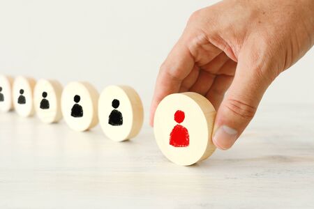 business concept image of wooden round blocks with people icons over the table, human resources and management conceptの写真素材